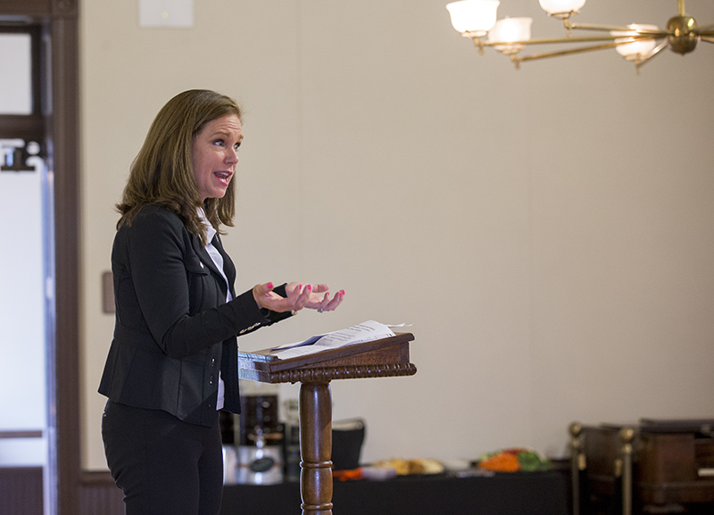 faculty member at conference making a point